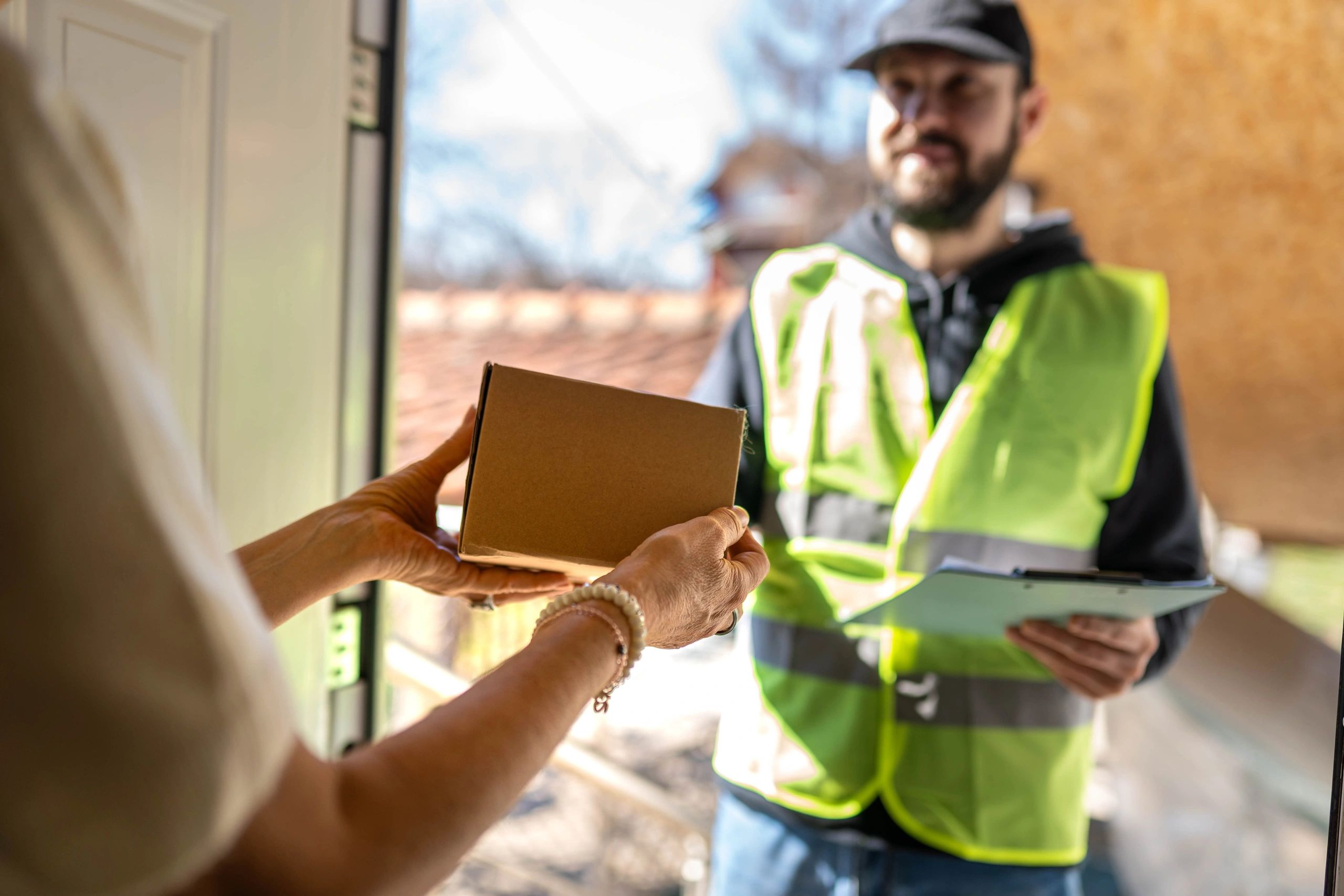 Courier collecting a parcel from a customer for same-day delivery
